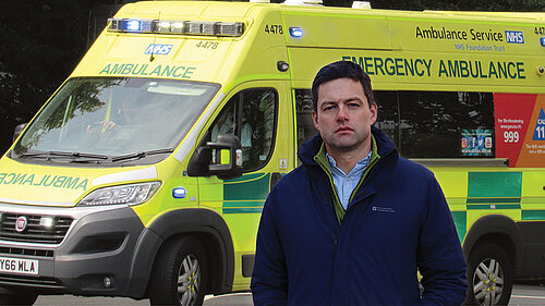 Chris by an ambulance